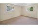 Bedroom featuring two windows with neutral walls and carpet at 8675 W 60Th Ave, Arvada, CO 80004