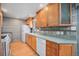 Bright kitchen featuring light wood cabinets, hardwood floors, and ample counter space for meal preparation at 8675 W 60Th Ave, Arvada, CO 80004
