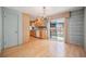 Open kitchen with hardwood floors, light wood cabinets, and a sliding glass door leading to the backyard at 8675 W 60Th Ave, Arvada, CO 80004