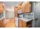 Cozy kitchen featuring light wood cabinetry, tiled backsplash, and modern appliances for comfortable cooking at 8675 W 60Th Ave, Arvada, CO 80004