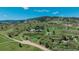 Beautiful aerial view of the property on rolling green hills with mountain views in the background at 1549 Hillside Cir, Sedalia, CO 80135