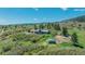 Expansive aerial view of property with a house, workshop, detached garage, and rolling green hills at 1549 Hillside Cir, Sedalia, CO 80135
