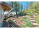 A landscaped yard featuring a stone pathway leading to the deck and backyard, showcasing beautiful outdoor living at 1549 Hillside Cir, Sedalia, CO 80135