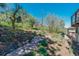 Backyard landscaping with a stone pathway, gardens, and natural setting with mountain views at 1549 Hillside Cir, Sedalia, CO 80135