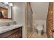 Bathroom featuring a vanity sink and tiled walk-in shower at 1549 Hillside Cir, Sedalia, CO 80135