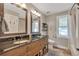 Bathroom featuring a double sink vanity, dark countertops, stylish fixtures, and a well-lit mirror at 1549 Hillside Cir, Sedalia, CO 80135