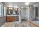 Bathroom with a tiled shower, dual sink vanity, and soaking tub for a spa-like experience at 1549 Hillside Cir, Sedalia, CO 80135