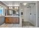 Elegant bathroom features a double sink vanity with a custom mirror and a frameless glass shower at 1549 Hillside Cir, Sedalia, CO 80135