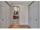 Hallway with view into the bathroom, with tile floors and dual sink vanity with wood cabinets at 1549 Hillside Cir, Sedalia, CO 80135