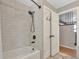 Bathroom featuring a tub with a shower head and a double door closet with access to the stairs at 1549 Hillside Cir, Sedalia, CO 80135