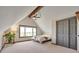 Charming bedroom with angled ceilings, a large window, and a closet with sliding doors at 1549 Hillside Cir, Sedalia, CO 80135