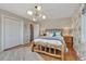 Inviting bedroom showcasing a wooden frame bed, hardwood floors, and stylish modern lighting fixture at 1549 Hillside Cir, Sedalia, CO 80135