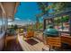 Relaxing wooden deck furnished with outdoor seating and an Egg-style BBQ grill, perfect for outdoor dining at 1549 Hillside Cir, Sedalia, CO 80135