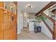 Inviting entryway with tile floors, wood door, staircase, and modern decor at 1549 Hillside Cir, Sedalia, CO 80135
