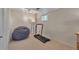 Bright workout room featuring a treadmill and beanbag chair on carpet flooring at 1549 Hillside Cir, Sedalia, CO 80135