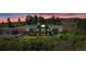 Expansive home with large windows, stone accents, a deck, mature trees and metal outbuilding at 1549 Hillside Cir, Sedalia, CO 80135