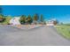 Home and adjacent metal outbuilding with a long driveway and plenty of parking space on gravel at 1549 Hillside Cir, Sedalia, CO 80135