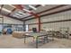 Spacious metal garage converted into a recreation room, complete with ping pong table and comfortable seating at 1549 Hillside Cir, Sedalia, CO 80135