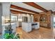 Bright kitchen featuring a central island, granite countertops, stainless appliances, and exposed brick at 1549 Hillside Cir, Sedalia, CO 80135