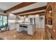Bright eat-in kitchen featuring white cabinets, stainless appliances, and center island with stone countertops at 1549 Hillside Cir, Sedalia, CO 80135