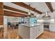 Bright kitchen showcasing wood-beamed ceilings, granite countertops and a large center island at 1549 Hillside Cir, Sedalia, CO 80135
