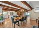 Spacious kitchen and dining area with wood beams, stainless appliances, and hardwood floors at 1549 Hillside Cir, Sedalia, CO 80135