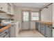 Bright laundry room with washer, dryer, storage cabinets, and natural light from a window at 1549 Hillside Cir, Sedalia, CO 80135
