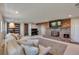 Comfortable living room with a large fireplace, a brick wall, and soft, neutral-toned furniture at 1549 Hillside Cir, Sedalia, CO 80135