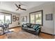 Cozy living room with hardwood floors, a comfortable sofa, a ceiling fan, and bright windows at 1549 Hillside Cir, Sedalia, CO 80135