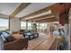 Bright living room with wood-beamed ceilings, an area for relaxing, and scenic outdoor views at 1549 Hillside Cir, Sedalia, CO 80135