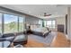 Inviting main bedroom with large windows, natural light, and views of mature trees at 1549 Hillside Cir, Sedalia, CO 80135