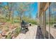 Outdoor patio with a smoker, natural stone details, and beautiful views and access to the backyard at 1549 Hillside Cir, Sedalia, CO 80135