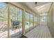 Bright sun room with multiple sliding glass doors leading to the backyard and skylight overhead at 1549 Hillside Cir, Sedalia, CO 80135