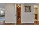 Walkway leading to a wine cellar with wood shelving, brick accents, and tiled flooring at 1549 Hillside Cir, Sedalia, CO 80135
