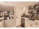 Basement bar with drink fridge, cabinet storage and access to the basement living room at 18963 E Long Ave, Centennial, CO 80016