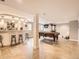 Open basement area with a bar, pool table, tile floors, and supportive column at 18963 E Long Ave, Centennial, CO 80016