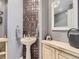 Charming powder room with a pedestal sink, decorative tiling, and a stylish mirror at 18963 E Long Ave, Centennial, CO 80016