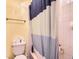 Cozy bathroom with a white and blue shower curtain, along with a toilet and towel bar at 18963 E Long Ave, Centennial, CO 80016