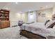 Spacious bedroom with a large bed, built-in shelves, a dresser, and carpeted floors at 18963 E Long Ave, Centennial, CO 80016