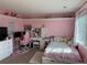 Bright pink bedroom featuring a large window, plush rug and bed, with white furniture and a workstation at 18963 E Long Ave, Centennial, CO 80016
