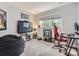 Fun ' bedroom with a large TV and a gaming chair by a window at 18963 E Long Ave, Centennial, CO 80016