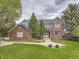 Stately brick home with a manicured lawn and mature trees evokes classic elegance and curb appeal at 18963 E Long Ave, Centennial, CO 80016