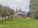 Beautiful home with a brick facade, balcony, and well-maintained lawn set against a cloudy sky at 18963 E Long Ave, Centennial, CO 80016