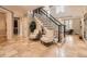 Elegant foyer featuring high ceilings, tile floors, and a staircase with black iron railings at 18963 E Long Ave, Centennial, CO 80016