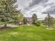 Expansive front yard showcasing lush landscaping and a charming brick home with excellent curb appeal at 18963 E Long Ave, Centennial, CO 80016
