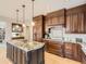 Gorgeous kitchen with a large island, wood cabinets, granite countertops, and stainless appliances at 18963 E Long Ave, Centennial, CO 80016