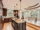 Spacious kitchen with a large island, granite countertops, wood cabinets, and a dining area at 18963 E Long Ave, Centennial, CO 80016