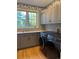 Well-lit laundry room with modern washer and dryer, ample counter space, and a view of the outdoors at 18963 E Long Ave, Centennial, CO 80016