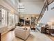 Cozy living room with a fireplace, built-in bookshelves, and large windows at 18963 E Long Ave, Centennial, CO 80016