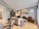 Cozy living room with fireplace, neutral decor, and hardwood floors creating a warm and inviting atmosphere at 18963 E Long Ave, Centennial, CO 80016